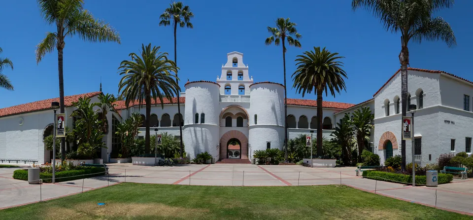 Hepner Hall’s white bell tower and palm trees at San Diego State University