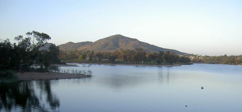 Cowles Mountain rising above the calm water and tree-lined shore of Lake Murray